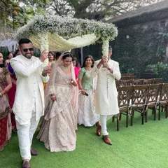 A close-up of the bride's entry under a canopy of baby's breath. This delicate and elegant floral chadar is one of our favorite ways to make the bridal procession truly special.