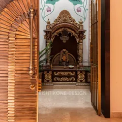 A glimpse into our double-height mandir through an intricately carved wooden door. The view reveals the traditional temple with gold detailing and the hand-painted mural, creating a sense of divine grandeur.