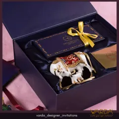 A luxurious gift box featuring a beautifully ornate Kamdhenu cow and calf idol, symbolizing prosperity and nourishment. This is a meaningful and elegant gift for weddings, festivals, or corporate clients.