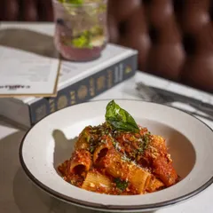 A classic bowl of Rigatoni Arrabbiata. The large tubes of pasta are perfect for catching the spicy, slow-cooked tomato sauce, and a sprinkle of cheese and herb crumbs adds the perfect finishing touch. It's simple, satisfying, and full of flavor.