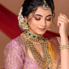 Soft, elegant, and timeless. This portrait showcases a beautiful engagement look, with a focus on the intricate details of the jewelry and the soft, romantic makeup. The pastel color palette adds a modern touch to the traditional attire.