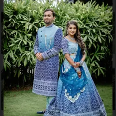 I believe a wedding is a celebration of two people, and their outfits should reflect that harmony. Here's a custom designed couple twinning lehenga and sherwani set in a striking blue, created to make sure they shine together.