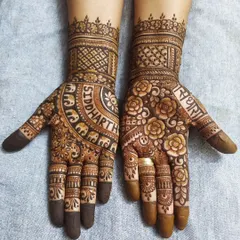 A beautiful example of combining names with patterns. One hand features the groom's name, "Siddharth," in an arch of elephants, while the other has the bride's name, "Radha," surrounded by a garden of roses.