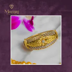 This handcrafted gold kada is as unique as the person who wears it. The intricate floral and leaf engraving is surrounded by rows of sparkling diamonds.