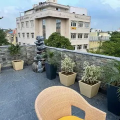 A rooftop terrace I designed for a commercial building in Ashok Vihar. The space includes a mix of potted plants, a stone-clad feature wall, and a water fountain, turning an empty roof into a relaxing retreat.