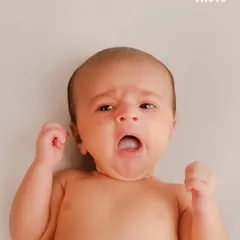 Capturing a big yawn. These fleeting, real-life moments are just as important as the perfect smile, telling the story of your baby's first days.