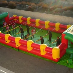 Bring team competition to your event with our Inflatable Human Foosball arena. Players are strapped to poles and must work together to score, creating a hilarious and engaging game for teens and adults.
