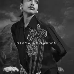 A black and white portrait featuring the Azalea shirt. The focus here is on the bold floral embellishments and the confident, elegant posture they inspire.