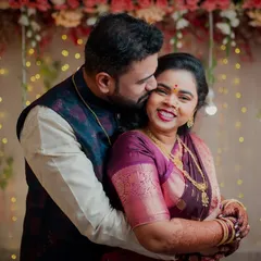Capturing the warmth and happiness of an engagement celebration. This couple shares a loving embrace against a backdrop of festive lights, perfectly showcasing the joy of the occasion.