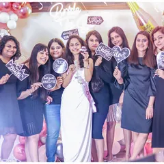 A moment of pure joy and friendship. The bride-to-be and her bridesmaids share a laugh during the bridal shower, creating memories that will last a lifetime in front of our fun balloon backdrop.