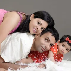 A pile of love. This sweet pose with the whole family lying on a soft white rug creates a warm, intimate portrait that feels natural and full of affection.