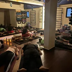A typical sound bath session where participants rest comfortably, immersed in healing vibrations. This shared experience in a tranquil group setting allows for a collective journey into deep relaxation and mindfulness.