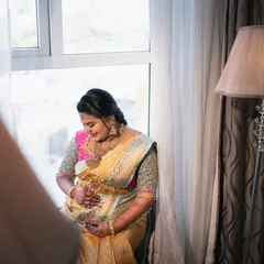 The quiet beauty of a mother-to-be, bathed in soft window light. This portrait captures the serene pregnancy glow and anticipation during her Seemantha.