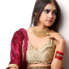 This image captures a classic bridal look, with the model adorned in a beautiful lehenga and traditional gold jewelry. It's a key shot for any model aspiring to work in the bridal fashion industry.