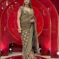 Get this royal saree in your wardrobe. A static shot of the stunning Banarsi saree, highlighting its intricate weave and rich color palette.