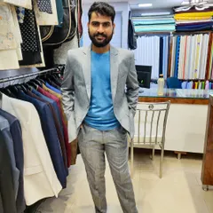 A full-length photo of the client in his light grey linen suit. It can be dressed up for a formal event or worn casually with a t-shirt for a modern business look.