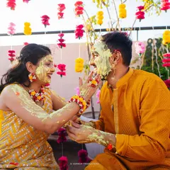 The Haldi ceremony is all about joy and vibrant color. We designed a beautiful floral curtain backdrop that made this couple's playful and happy moments even more memorable.
