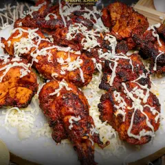Presenting our Chicken Cheese Overload Tandoori. We take juicy, smoky tandoori chicken and drench it in a generous layer of molten cheese. This is pure indulgence, a cheesy and smoky delight that's become a crowd favorite.