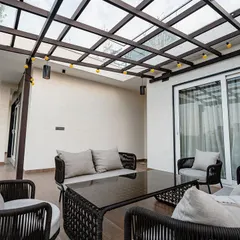 We transformed this balcony into a stylish retreat with classic outdoor seating, cozy cushions, and warm ambient lighting for the perfect evening atmosphere.