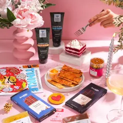 A beautifully styled flat lay for a Valentine's collaboration between a snack and a skincare brand. The pink background, fresh flowers, and carefully placed products create a romantic and gift-worthy scene.