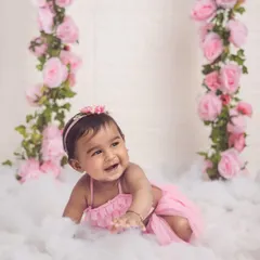 This is one of our favorite setups. A baby girl crawls through soft "clouds" with beautiful pink rose vines, creating a dreamy and whimsical scene.