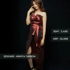 This metallic red cocktail dress by Nikhita Tandon is designed for a glamorous night out. The strapless, draped silhouette is both bold and sophisticated, offered at a fraction of its original price.