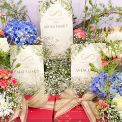 This is another view of the blossom-themed hamper, highlighting the balance between the soft florals and the rich red gift boxes tied with jute ribbons. It’s a design that is both grand and thoughtfully detailed.