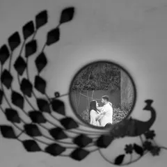 An artistic black and white shot capturing the reflection of the couple in a mirror. It’s a creative way to frame their intimacy and connection.