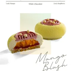 The Mango Blush entremet is a play of juicy mango and punchy raspberry. The cross section shows how they are swirled into an airy white chocolate mousse and set on a soft vanilla sponge.