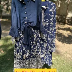 A sophisticated twinning set for siblings. This navy blue floral print is available in a girls' skirt and tie-front top, and a matching boys' kurta.