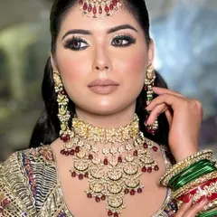 A full portrait of the blue eyeshadow look, showing how it ties together with the intricate, multi-colored lehenga.