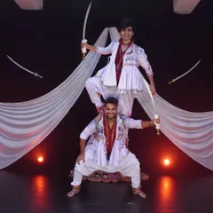 A powerful pose from our Talwar Raas piece. This form of Garba uses swords not for aggression, but as a way to celebrate with respect and honor, making it a visually stunning addition to any stage performance.