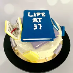 Would you read this cake or eat it first? This 'Life at 37' cake, complete with edible books, is for the book lover who's aging like a bestseller.