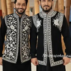 Two clients wearing coordinated but distinct black and white embroidered waistcoats. This shows how I can create a unified theme for a groom and his family or groomsmen.