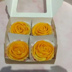 A box of four mini mango tarts, ready to be gifted or enjoyed. Each tart is handcrafted with the same attention to detail, ensuring a perfect bite every time.