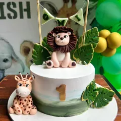 Roar! This adorable jungle theme cake was for little Omi's first birthday. We designed it with a cute fondant lion and giraffe, all without using fondant on the cake itself for a delicious buttercream finish.