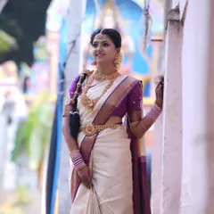 For my beautiful South Indian brides, it's all about timeless elegance. This Murtham look features glowing skin, defined eyes, and makeup that enhances her features while perfectly matching the grandeur of her silk saree and temple jewellery.