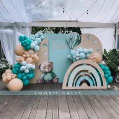 A sweet teddy bear theme perfect for a baby shower or first birthday. This setup features a gentle color palette of teal and beige, with a cute bear, a rainbow accent, and hot air balloon details for a whimsical touch.