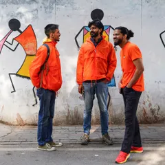 Our guides sharing a laugh in front of a colorful wall. Their camaraderie, humor, and deep knowledge of the city are what make our tours so engaging and fun.