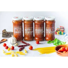A group shot of The Gourmet Jar's pasta sauce range. This clean, bright image clearly displays the different labels and products, with fresh ingredients scattered around to suggest flavor and quality. It's an ideal banner image for a website or catalog.