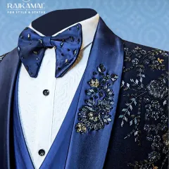 It's all in the details. This close-up highlights the exquisite hand-embroidery on the lapel of a navy blue tuxedo, paired with a custom-beaded bow tie. This is the level of craftsmanship I bring to every garment.