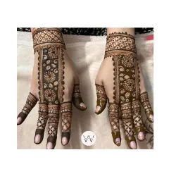 A lovely symmetrical design for a bridesmaid, with a floral belt pattern on the back of the hands.