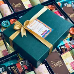 We specialize in creating premium corporate gifts that make a statement. This Diwali hamper, designed for a corporate client, features a sophisticated green and gold theme, filled with gourmet treats and festive essentials, ready for bulk delivery.