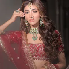 Here, I styled a classic red lehenga with a contemporary twist. The focus is on the stunning emerald and polki jewelry from Nirakara Jewels, which provides a beautiful contrast against the red, creating a look that is both traditional and fresh.
