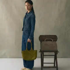 The Penny Carryall in suede, seen here next to our Foyer Bamboo bag. It’s a perfect example of how we play with different textures to create statements.