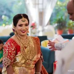 A candid moment of happiness. This bride's joyful smile says it all. Her makeup was kept classic and radiant to match her beautiful red and gold silk saree for her South Indian wedding.