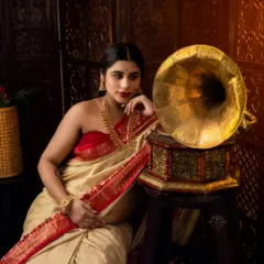 We blend tradition with art in this conceptual maternity saree shoot. This portrait, inspired by classic Indian aesthetics with a vintage gramophone, captures a timeless elegance and quiet contemplation.