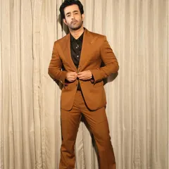This full-length view of Satyajeet Dubey's brown suit highlights the perfect fit and flare of the trousers, designed to complement the structured jacket. It's a complete look rooted in traditional craftsmanship.