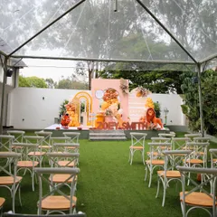 A "Lion King" themed first birthday party at The Backyard. The clear-top tent ensures a weather-proof event, while the themed decor on the stage creates a fun and memorable setting.