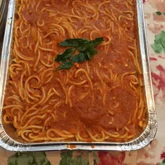 A simple, classic spaghetti in a homemade tomato sauce, topped with fresh basil. It's a crowd-pleasing dish that I often include in my Continental catering menus.